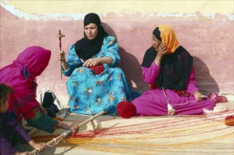 EGYPT, West Desert, Bedouin women spinning yarn