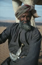 OMAN, Wahiba Sands, People, "Man wearing a khanjar, a traditional curved dagger attached to his