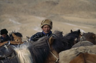 MONGOLIA, Bayan Olgii Province, Kazakh nomads on horseback gather for Kazakh New Year horse race