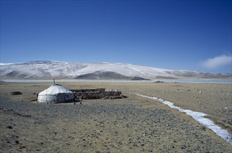 MONGOLIA, Bayan Olgii Province, View over Kazakh nomad camp with single yurt and livestock coral