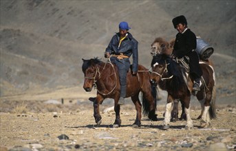 MONGOLIA, Bayan Olgii Province, Kazakh men on their way to the Kazakh New Year festivities riding