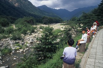 SOUTH KOREA, Soraksan Nat. Park, Sorak Mountains, Ssang-Chon River.  Children sitting beside almost