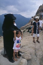 SOUTH KOREA, Soraksan Nat. Park, Sorak Mountains, "Tourists crowd onto Chipsonbong summit, child