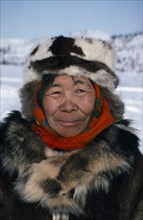 RUSSIA, Kamchatka, Koryak woman.  Head and shoulders portrait outside dressed in furs.
