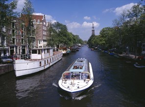 HOLLAND, Noord, Amsterdam, Glass top tourist boat travelling down the Prinsengracht canal