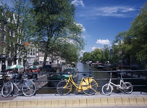 HOLLAND, Noord, Amsterdam, Bicycles leaning against the railings of a bridge over the Prinsengracht