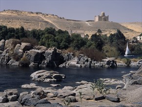 EGYPT, Nile Valley, Aswan, Feluccas on the Nile. View of Felucca sailing among the boulders off