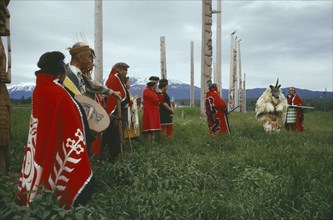 CANADA, British Columbia,  Kwakiutl, Native Indian Kwakiutl tribe totem poles with tribesmen and a