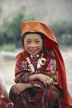 AFGHANISTAN, Children, Portrait of Kirghiz girl in traditional dress.