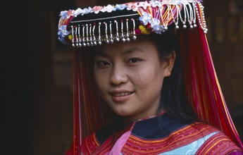 THAILAND, Chiang Rai, Tribal People, Portrait of Lisu girl wearing traditional head dress.