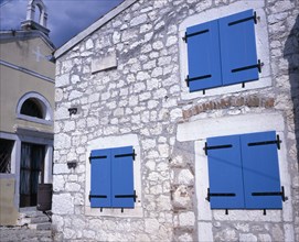 CROATIA, Rovinj, Old town church and cottage with blue painted shuttered windows