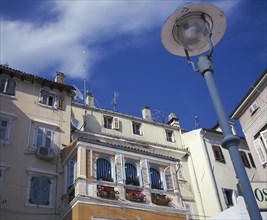 CROATIA, Rovinj, Traditional shuttered houses with window boxes overlooking the harbour