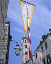 CROATIA, Dalmatia, Dubrovnik, Vatican City flags on Placa and view of Franciscan Monastery