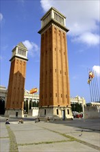 SPAIN, Catalonia, Barcelona, Placa d Espanya. Angled view of the two 154ft high brick campaniles by