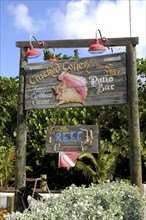 WEST INDIES, Cayman Islands, Cracked Conch by the Sea Patio Bar sign