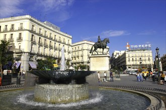 SPAIN, Madrid, Equesetrian statue seen over fountain in central plaza
