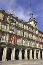 SPAIN, Madrid, Plaza Mayor with flags hanging over archways and spire above