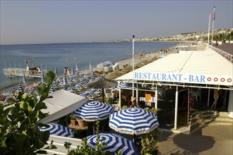 FRANCE, Cote d Azur, Nice, View over restaurant umbrellas to the beach