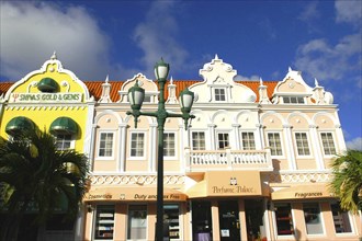 WEST INDIES, Dutch Antilles, Aruba, Oranjestad. Shop fronts with colonial style facades in pastel