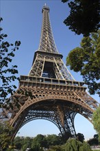 FRANCE, Ile de France, Paris, Angled view looking up at the Eiffel Tower