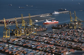 SPAIN, Catalonia, Barcelona, Container port with ships and cranes.