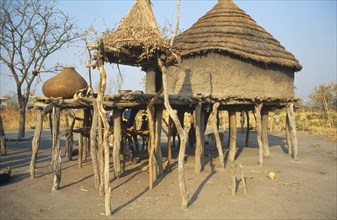 SUDAN, South, Bahr el Ghazal, Thatched mud house raised on wooden stilts in Dinka village.