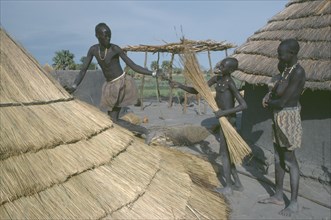 SUDAN, People, Dinka tribe thatching hut in cattle camp.