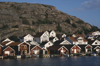 SWEDEN, Hunnebostrand, Traditional red painted houses beside the quay at the fishing village