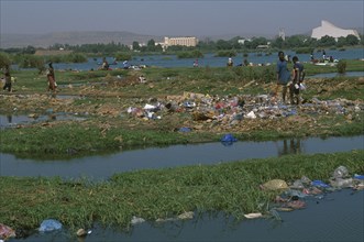 MALI, Bamako, View over the city across a rubbish tip and River Niger with people scavenging
