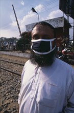BANGLADESH, Dhaka, Bearded man wearing a mask covering his mouth and nose against air pollution