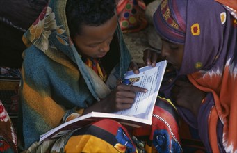 SOMALIA, People, Baidoa girls reading text books produced by UNICEF