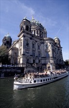 GERMANY, Berlin, Berlinerdom with passing tourist boat