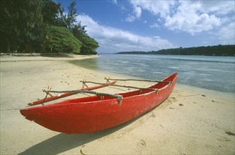 PACIFIC ISLANDS, Melanesia, Vanuatu Islands, Efate Island.  Red outrigger canoe moored on sandy