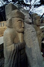 SOUTH KOREA, Tongdosa, Carved Guardian Stones standing in a row at the Buddhist Temple