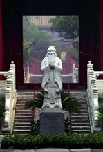 CHINA, Beijing, Statue of Confucius on engraved plinth at the bottom of some steps