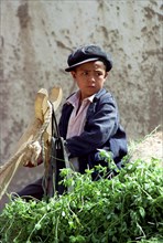 CHINA, Xinjiang, Kashgar, Portrait of a young boy wearing a cap