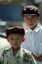CHINA, Xinjiang, Kashgar, Portrait of two yound boys wearing caps