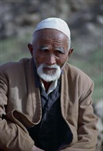 CHINA, Xinjiang, Kashgar, Portrait of a man wearing a cap