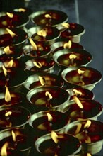 CHINA, Tibet, Lhasa, Jokhang Temple. Close up of prayer lamps fueled with Yak butter
