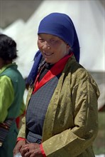 INDIA, Ladakh, Portrait of female pilgrim at the 14th Dalai Lamas birthday celebrations