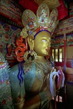 INDIA, Ladakh, Tikse, Elaborately decorated golden Maitreya or Future Buddha statue at Tikse Gompa