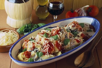 ITALY, Food and Drink, "Tortelloni in tomato and wild mushroom sauce in serving dish displayed with