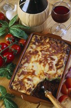 ITALY, Food and Drink, "Lasagne in serving dish with basil, tomatoes and red wine."