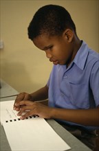 CARRIBEAN, Grenada, St Vincent, Blind boy learning Braille at St Pauls School for the blind