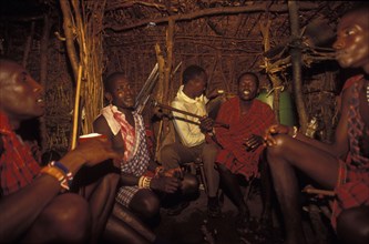 KENYA, , Maasai moran young warriors drinking milk during an initiation ceremony which brings them