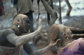 SUDAN, Body Decoration, Dinka hairdressing.  Hair is trimmed into shape and dyed with cattle urine.