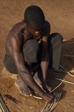 CENTRAL AFRICAN REPUBLIC, People, Sango tribesman making fishing traps with twigs and reeds