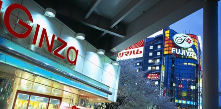 JAPAN, Honshu, Tokyo, Ginza District. City architecture with large advertising signs illuminated at