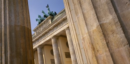 GERMANY, Berlin, Brandenburg Gate. Angled view looking up through pillars toward the crowning