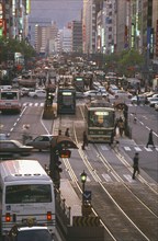 JAPAN, Honshu, Hiroshima, Aioi Street with city traffic either side of a central tram line and